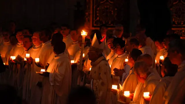 Cardinal Giovanni Battista Re (C) holds a candle during the Easter Vigil mass in Saint Peter's Basilica at the Vatican City, 19 April 2025. ANSA/FABIO FRUSTACI