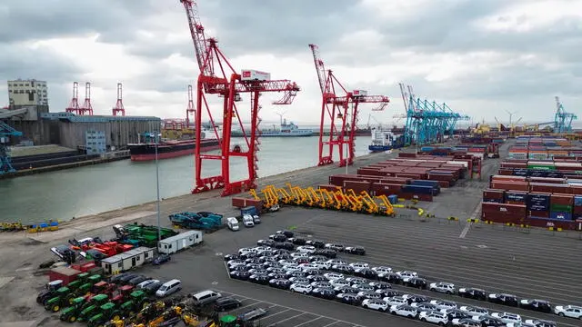 epa11880928 An aerial photograph taken with a drone of cars and JCBs lined up in front of stacked containers at Seaforth Dock container terminal in Liverpool, Britain, 07 February 2025. US President Donald Trump has imposed 10 percent tariffs on China, with planned tariffs on Mexico and Canada being delayed after last minute talks. The US President has said that tariffs may also be imposed on the EU and the UK, which exports goods and services including energy, cars, machinery and pharmaceuticals to the US. EPA/ADAM VAUGHAN