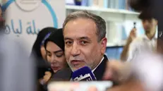 epa12055235 Iran's Foreign Minister Abbas Araghchi (R) talks to the media during the launching of his book 'The Power of Negotiation', at the Muscat International Fair on the sidelines of his attendance at the third round of indirect talk between Iran and the US, in Muscat, Oman, 25 April 2025. Iran and US will hold the third round of talks in Muscat on 26 April 2025. EPA/ALI HAIDER