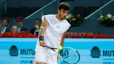 epa12066183 Lorenzo Musetti of Italy in action against Alex de Minaur of Australia during their round of 16 tennis match at the Mutua Madrid Open tennis tournament in Madrid, Spain, 30 April 2025. EPA/JUANJO MARTIN
