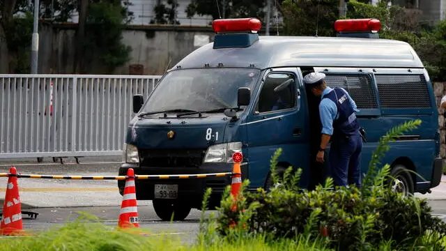 epa11667963 A police officer inspects the police van hit a Molotov cocktail before the ruling Liberal Democratic Party's headquarters, in Tokyo, Japan, 19 October 2024. In the early morning hours, a man threw Molotov cocktails toward the Liberal Democratic Party (LDP) headquarters and crashed his car into a fence at the Prime Minister's Office. According to the Metropolitan Police Department, the man was arrested on the spot, and no one was injured. EPA/FRANCK ROBICHON