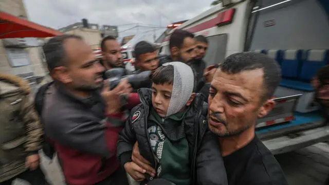 epa11740150 A man carries a wounded boy at Al Aqsa martyrs hospital following an Israeli air strike in Al Bureij refugee camp, central Gaza Strip, 25 November 2024. More than 44,200 Palestinians and over 1,400 Israelis have been killed, according to the Palestinian Health Ministry and the Israeli Army, since Hamas militants launched an attack against Israel from the Gaza Strip on 07 October 2023, and the Israeli operations in Gaza and the West Bank which followed it. EPA/MOHAMMED SABER