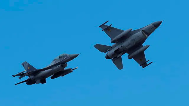 epa10973359 Two Romanian military jet pilots fly their F16 Falcons during a demo flight following the opening ceremony for the European F-16 Training Center, held at the 86th Air Base 'Lieutenant Aviator Gheorghe Mociornita', in Borcea, Romania, 13 November 2023. The ETFC it is the first European dedicated training facility outside the United States territory that had all the means for training F16 pilots in order to facilitate the interoperability between NATO member countries. According to the project contract, Romanian Defense Ministry put the 86th Air Base at the training hub's disposal, including the tech training facilities and logistic support. The Netherlands already gave four pieces of F16 jet fighters for the training flights, and US company Lockheed Martin comes with the instructors and maintenance. At the EFTC are supposed to get the training the Ukrainian pilots that will handle the F16 that Ukraine will receive from its western allies, according to the NATO decision. EPA/Robert Ghement