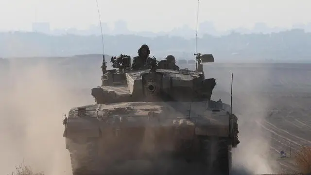 epa11264264 An Israeli army tank moves along the border with Gaza in southern Israel , 07 April 2024. Israel marks six months since the October 07 attacks, as 134 hostages are currently still being held captive in Gaza, according to the Israeli IDF. More than 33,000 Palestinians and over 1,450 Israelis have been killed, according to the Palestinian Health Ministry and the Israel Defense Forces (IDF), since Hamas militants launched an attack against Israel from the Gaza Strip on 07 October 2023, and the Israeli operations in Gaza and the West Bank which followed it. EPA/ABIR SULTAN