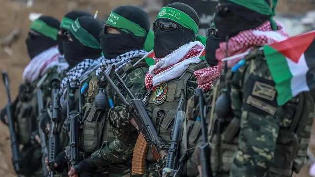 epa11863421 Armed fighters of the Ezz al-Din Al-Qassam brigades, the military wing of Hamas, stand guard prior to the release of Israeli hostage Agam Berger (unseen), at Jabaliya refugee camp in the northern Gaza Strip, 30 January 2025. Hamas freed eight hostages on the day, among them Israeli soldier Agam Berger, with Israel expected to release 110 Palestinian prisoners in exchange. This marks the third such exchange in the first phase of an Israeli-Hamas hostage release and ceasefire deal implemented on 19 January 2025. EPA/MOHAMMED SABER