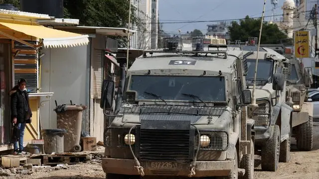 epa11922151 Israeli troops during a military operation inside the Jenin refugee camp, West Bank, 24 February 2025. The Israeli military launched a military operation in Jenin and its camp on 21 January, resulting in at least 27 Palestinian deaths and dozens of injuries, according to the Palestinian Ministry of Health. EPA/ALAA BADARNEH