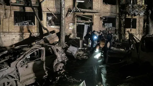 epa12050432 Ukrainian rescuers work at the site where a rocket struck a residential building in Kyiv, Ukraine, 24 April 2025, amid the ongoing Russian invasion. Russia launched a large-scale overnight attack using a combination of drones and various types of rockets. At least two people were killed and 54 others injured, including six children, in the strike on the residential building. EPA/SERGEY SHESTAK