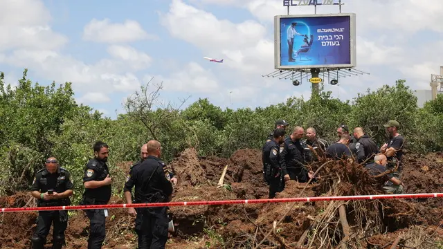 epa12072594 Police inspect the damage caused by a ballistic missile fired from Yemen at the Ben Gurion airport near Tel Aviv, Israel, 04 May 2025. According to Israel's military spokesperson, a ballistic missile fired from Yemen hit at the Ben Gurion airport. Yemen's Houthis have claimed responsibility for launching the missile. EPA/ABIR SULTAN