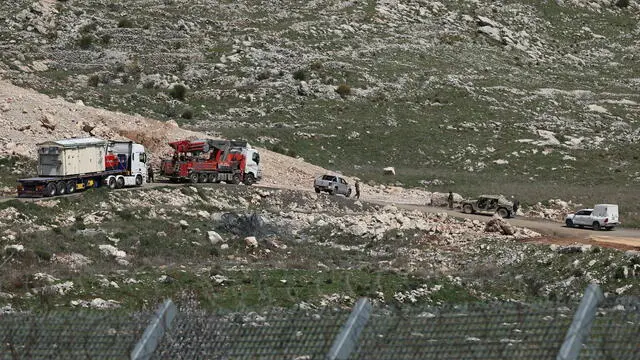 epa11960631 Israeli military trucks carrying materials alongside Israeli troops at the buffer zone on the border between Israel and Syria, near the Druze village of Majdal Shams, in the Israeli-annexed Golan Heights, 13 March 2025. In a statement on social media platform X on 07 March 2025 Israeli Defense Minister Israel Katz said "Israel will remain in the security zones and Mount Hermon". EPA/ATEF SAFADI