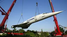 Huge cranes lift the former Air France supersonic jet Concorde to the museum of technics in Sinsheim, southern Germany on Sunday, 20 July 2003, at the end of its three-days final journey from Baden airport near Karlsruhe. EPA PHOTO/DPA/Ronald Wittek