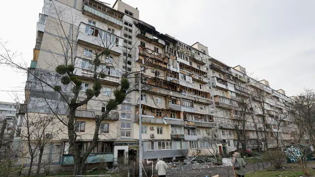 epa11982493 Ukrainians inspect the site of an overnight drone attack on a nine-story residential building in Kyiv, Ukraine, 23 March 2025 amid the ongoing Russian invasion. At least three people were killed an another 8 were injured in an overnight Russian drone attack in Ukraine according to the Ukrainian army and the State Emergency Services. EPA/SERGEY DOLZHENKO