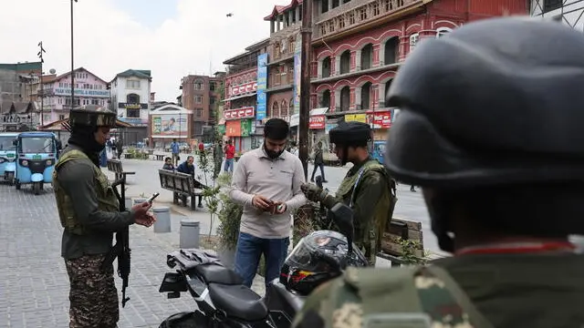 epa12072572 Indian paramilitary soldiers check a pedestrian in Srinagar, India, 04 May 2025. Authorities increased security following the 22 April deadly attack in Pahalgam, India-administered Kashmir, that left 26 people dead. EPA/FAROOQ KHAN