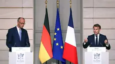 epa12079923 French President Emmanuel Macron (R) and German Chancellor Friedrich Merz (L) attend a news conference following their meeting at the Elysee Palace in Paris, France, 07 May 2025. The German Chancellor visits France and Poland the day after his election. EPA/HANNIBAL HANSCHKE