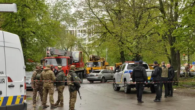epa11284263 Police officers keep watch behind a cordon near the site of a missile strike in Chernihiv, northern Ukraine, 17 April 2024, amid the Russian invasion. At least 17 people were killed and 60 others injured, including three children, following a Russian missile strike in Chernihiv, the State Emergency Service of Ukraine (SESU) said, adding that a search and rescue operation was ongoing. A social infrastructure facility, a hospital, and several residential high-rise buildings were damaged as a result of the morning rocket attack in Chernihiv, north of Kyiv, Ukrainian officials said. EPA/NATALIA LEVDOKYMOVA