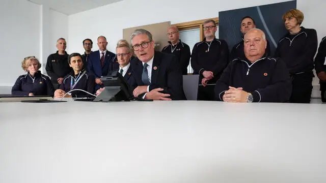 epa12083839 British Prime Minister Keir Starmer (C) during a phone conversation with US President Donald Trump from a Jaguar Land Rover automobile manufacturing plant in the West Midlands, Britain, 08 May 2025. Trump said the US has secured what he described as a comprehensive trade agreement with the UK, the culmination of weeks of talks between the two allies and marking the first of his promised deals with countries around the world. EPA/DARREN STAPLES / POOL