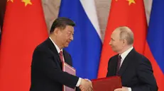 epa12083253 Russian President Vladimir Putin (R) and Chinese President Xi Jinping shake hands as they attend a signing documents ceremony at the Kremlin in Moscow, Russia, 08 May 2025. Russia will mark the 80th anniversary of the victory in World War II over Nazi Germany and its allies on 09 May. EPA/YURI KOCHETKOV