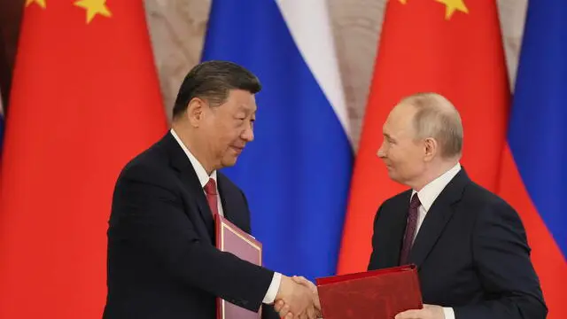 epa12083253 Russian President Vladimir Putin (R) and Chinese President Xi Jinping shake hands as they attend a signing documents ceremony at the Kremlin in Moscow, Russia, 08 May 2025. Russia will mark the 80th anniversary of the victory in World War II over Nazi Germany and its allies on 09 May. EPA/YURI KOCHETKOV