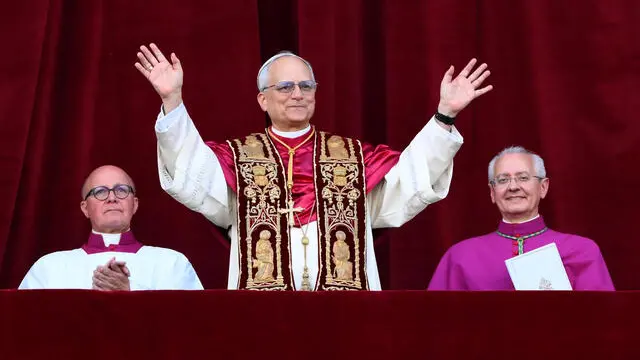 Cardinal Robert Francis Prevost (C) blesses from a balcony of St Peter's Basilica after his election as the 267th pope of the Roman Catholic church, Vatican City, 08 May 2025. ANSA/ETTORE FERRARI