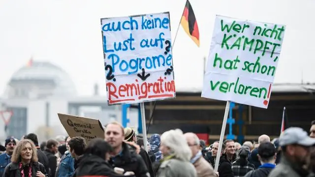 epa07157991 Protesters hold placards reading 'Also no desire for pogroms? - Remigration' (L) and 'Who doesn't fight has already lost!' as they demonstrate against the so-calleed UN Migration Pact, in Berlin, Germany, 11 November 2018. Several Members of Parliament of the right-wing populist Alternative for Germany (Alternative fuer Deutschland, AfD) party called for a demonstration against the UN-proposed agreement. Already three days ago at the German 'Bundestag' parliament the AfD brought in a motion asking Germany to withdraw from the UN agreement. The Global Compact for Safe, Orderly and Regular Migration (GCM) is a non-binding 'intergovernmentally negotiated agreement, prepared under the auspices of the United Nations', meant to cover 'all dimensions of international migration in a holistic and comprehensive manner'. Some countries such as Austria, Australia, Croatia, Hungary and Poland already declared not to sign the agreement. EPA/CLEMENS BILAN