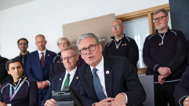 epa12083841 British Prime Minister Keir Starmer (C) during a phone conversation with US President Donald Trump from a Jaguar Land Rover automobile manufacturing plant in the West Midlands, Britain, 08 May 2025. Trump said the US has secured what he described as a comprehensive trade agreement with the UK, the culmination of weeks of talks between the two allies and marking the first of his promised deals with countries around the world. EPA/DARREN STAPLES / POOL