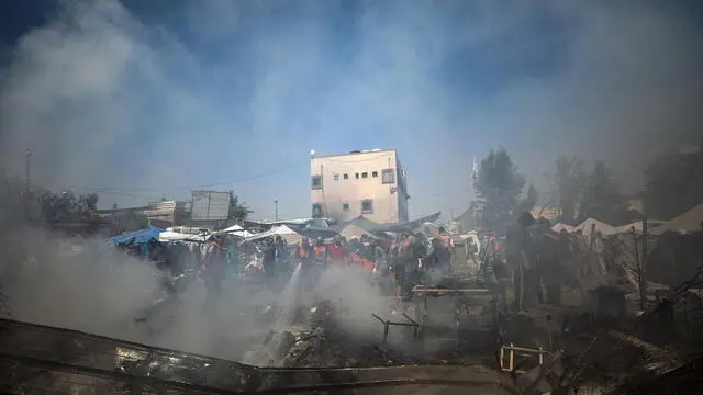 epa12044303 Palestinian Civil Defense personnel put out a fire burning in destroyed tents of internally displaced Palestinians following an Israeli air strike in Gaza City, 21 April 2025. According to the Palestinian Ministry of Health in Gaza, at least three Palestinians were killed, and ten were wounded in the airstrike. EPA/MOHAMMED SABER
