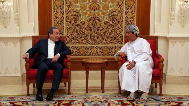 epa12090459 A handout photo made available by the Iranian Foreign Ministry shows Iranian Foreign Minister Abbas Araghchi (L) meeting with an unidentified Omani official in Muscat, Oman, 11 May 2025. Iran and the US hold their fourth round of nuclear talks in Muscat on the same day. EPA/IRANIAN FOREIGN MINISTRY HANDOUT EDITORIAL USE ONLY/NO SALES