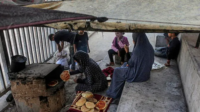 epa12075562 An internally displaced Palestinian woman prepares bread inside Al Yarmouk stadium in central Gaza City, the Gaza Strip, 05 May 2025. According to the UN, at least 1.9 million people (or nine in ten people) across the Gaza Strip are internally displaced, including people who have been repeatedly displaced. Since October 2023, only about 11 percent of the Gaza Strip has not been placed under Israeli-issued evacuation orders, the UN aid coordination office OCHA said. EPA/MOHAMMED SABER