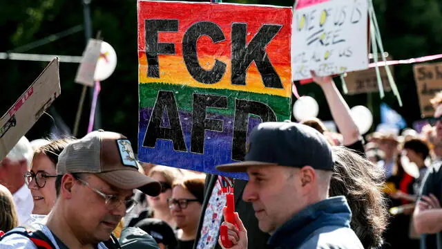 epa12091935 People hold placards while taking part in a demonstration calling for a ban on Germany's far-right AfD party under the slogan 'No more excuses! AfD ban now!', in front of the Brandenburg Gate in Berlin, Germany, 11 May 2025. EPA/FILIP SINGER