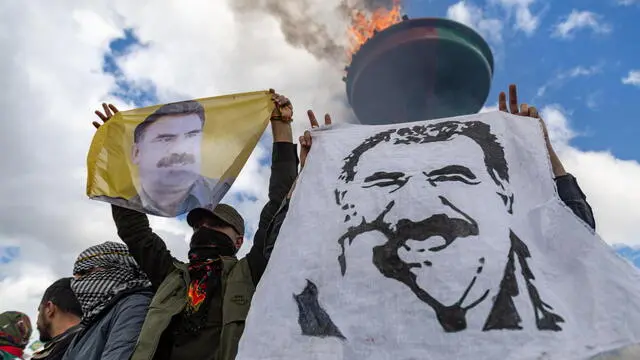 epa11978446 Supporters of The Peoples' Equality and Democracy Party (DEM) hold pictures of Kurdistan Workers' Party (PKK) jailed leader Abdullah Ocalan, and shout slogans next to a bonfire during a rally for Newruz celebrations in Diyarbakir, Turkey, 21 March 2025. Newroz or Nowruz, which means 'new day' in the Persian language, marks the arrival of spring and the first day in the Iranian calendar. It is widely celebrated in the Persian and neighboring regions and recognized on the UNESCO List of the Intangible Cultural Heritage of Humanity. EPA/METIN YOKSU