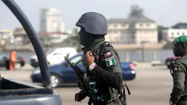 epa09009398 A armed policeman stands guard at the Lekki toll plaza, the flash point of a street protest against police brutality last October, in Lagos, Nigeria, 13 February 2021. Activists have called for a renewed protest following a judicial panel authorization of reopening the city's toll gate where the military shot at peaceful protesters on 20 October 2020. EPA/AKINTUNDE AKINLEYE
