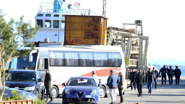 epa12025580 A bus transporting migrants who arrived aboard the Italian navy ship Libra departs from the port in Shengjin, Albania, 11 April 2025. The Navy ship Libra departed from Brindisi with 40 migrants on board, who recently arrived at a stay and repatriation center (CPR), and the Italian government has mandated their transfer to a facility in Gjader, Albania. EPA/MALTON DIBRA