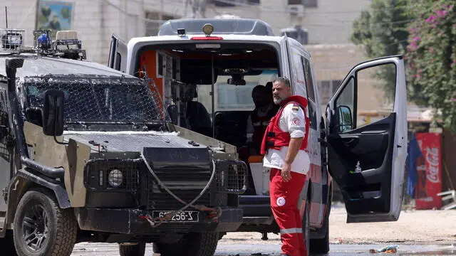 epa11570839 The Israeli army search an ambulance outside a hospital during a military operation in the West Bank city of Jenin, 29 August 2024. According to the Palestinian Health Ministry, at least 12 Palestinians were killed after Israeli operations in the northern West Bank cities of Tulkarem, Jenin and Tubas that started on 28 August. The Israeli army said they were conducting a large-scale counterterrorism operation in several areas including Jenin and Tulkarem. They added that five Palestinians were killed after fire exchanges inside a mosque in Tulkarem on 29 August. EPA/ALAA BADARNEH