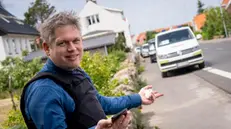 epa10692523 Far-right politician Rasmus Paludan stands outside the prohibition zone in Allinge on Bornholm, Denmark, 15 June 2023. Rasmus Paludan has been ordered by the Bornholm Police not to participate in the Folkemodet (a public meeting) and is therefore outside the prohibition zone a few hundred meters from the Folkemodet. Rasmus Paludan burned a copy of the Koran at a rally in Stockholm on 21 January, drawing worldwide condemnation. EPA/Ida Marie Odgaard