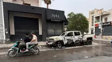 epa12099533 A damaged vehicle pictured in the street after clashes in Tripoli, Libya, 14 May 2025. Flights at Mitiga Airport were suspended due to clashes while the Ministry of Education had suspended classes in schools in the capital. EPA/STRINGER