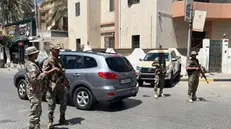 epa12096216 Libyan security forces stand guard at a checkpoint following overnight clashes in Tripoli, Libya, 13 May 2025. Clashes in the Libyan capital have left at least six people dead, according to Libya's Emergency Medicine and Support Centre. EPA/STRINGER