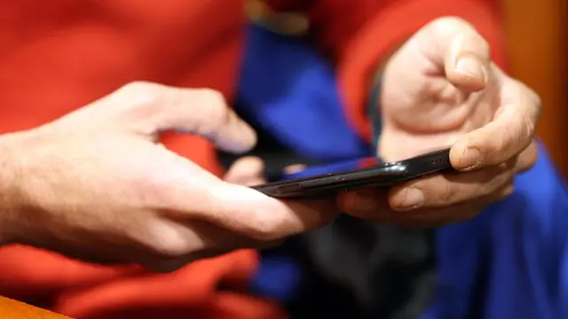 epa11796284 A man uses his smartphone while sitting in a cafe in Tehran, Iran, 28 December 2024. The Iranian government on 27 December 2024 unblocked Whatsapp and Google Play after two years, while the rest of the social media such as Telegram, Instagram, X and YouTube remain blocked. EPA/ABEDIN TAHERKENAREH