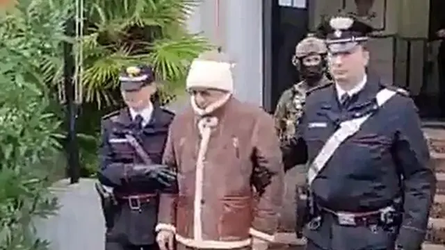 A handout photo made available by Italy's Carabinieri shows a video frame of the Mafia boss Matteo Messina Denaro (C), Italy's most wanted man, being arrested in Palermo, Sicily, by the Carabinieri police's ROS unit after 30 years on the run in Palermo, Sicily island, Italy, 16 January 2023. ANSA/US CARABINIERI +++ NO SALES, EDITORIAL USE ONLY +++ NPK +++
