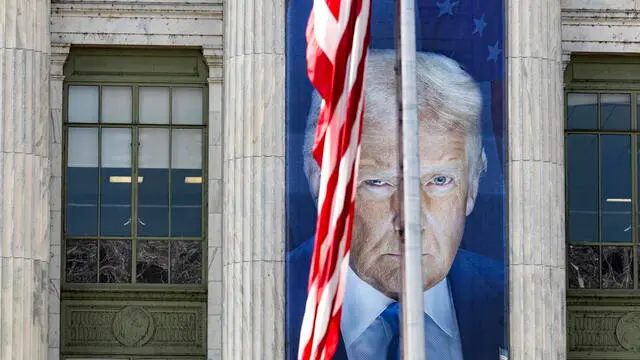 epa12107221 A giant banner of U.S. President Donald Trump hangs from the Department of Agriculture (USDA) in Washington, DC, 16 May 2025. More than 15,000 USDA employees have accepted the Trump administration’s offer for voluntary resignation as of 01 May. EPA/JIM LO SCALZO