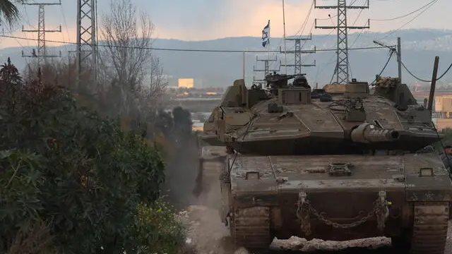 epa11919298 Israeli forces with tanks enter Jenin refugee camp in the West Bank city of Jenin, 23 February 2025. The Israeli military launched a military operation in Jenin and its camp on 21 January, resulting in at least 27 Palestinian deaths and dozens of injuries, according to the Palestinian Ministry of Health. EPA/ALAA BADARNEH