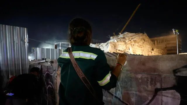 epa11994916 A woman prays for her husband during a rescue operation at the site of a collapsed building following an earthquake in Bangkok, Thailand, 28 March 2025. According to the National Institute for Emergency Medicine, dozens of construction workers are feared trapped following the collapse of a high-rise building in Bangkok, due to a 7.7-magnitude earthquake that struck Myanmar, causing tremors that could be felt in neighboring Thailand. EPA/NARONG SANGNAK
