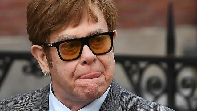 epa10545723 British musician Sir Elton John departs the High Court in London, Britain, 27 March 2023. John has appeared at the High Court in a hearing related to his privacy lawsuit against Associated Newspapers. John appeared along with others who are suing the Daily Mail newspaper over phone tapping and breaches of privacy. EPA/ANDY RAIN