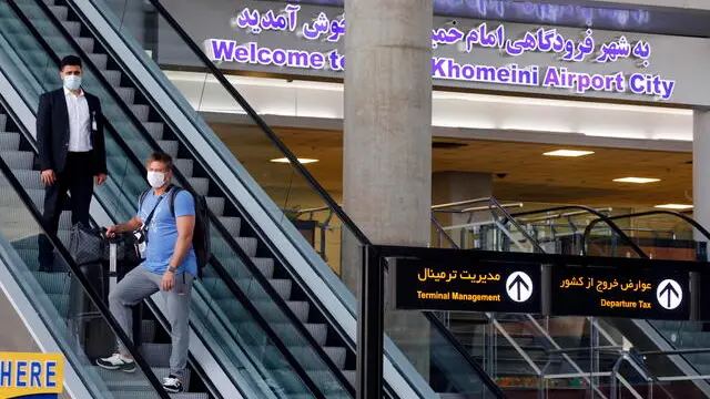epa08551623 Passengers arrive at the Imam Khomeini international airport, south of the capital city of Tehran, Iran, 17 July 2020. Media reported that after six month of closure over the Covid-19 pandemic, the Emirates airline landed its first flight in Iran on 17 July 2020. Iranian Mohmmad Reza Karimian the CEO of the Imam Khomeini international airport said that all the health protocols are applied in the airport. EPA/ABEDIN TAHERKENAREH