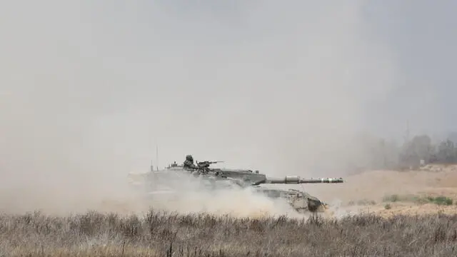 epa11379315 Israeli army tank moves along the border with the Gaza Strip, southern Israel, 30 May 2024. More than 36,000 Palestinians and over 1,400 Israelis have been killed, according to the Palestinian Health Ministry and the Israel Defense Forces (IDF), since Hamas militants launched an attack against Israel from the Gaza Strip on 07 October 2023, and the Israeli operations in Gaza and the West Bank which followed it. EPA/ABIR SULTAN