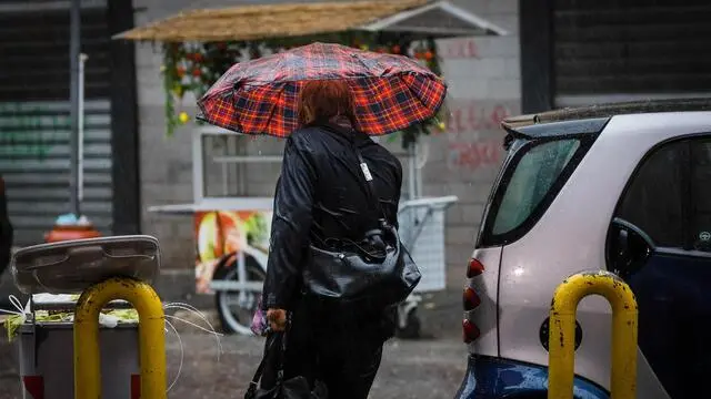 Passers-by protect themselves with an umbrella during a rainfall in Naples, southern Italy, 03 November 2019. ANSA/ CESARE ABBATE