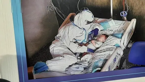 Un momento della cerimonia, svoltasi agli Ospedali Riuniti, per ricordare la vicenda del bimbo ricoverato a marzo per Covid all'ospedale materno infantile 'Salesi' di Ancona, che era era stata immortalata in una foto divenuta virale sul web: lo scatto ritraeva il piccino sul letto in Rianimazione Pediatrica, con accanto l'infermiera Katia Sandroni, bardata in tuta anti-contagio, che lo accarezzava tenendogli il ciuccio, Ancona, 31 maggio 2021. Un simbolo dell'impegno e dell'umanit�?� degli operatori sanitari che da oltre un anno sono impegnati nella lotta contro la pandemia. Oggi i genitori del bimbo, Roberta ed Enrico, insieme al figlio, hanno partecipato con gratitudine alla cerimonia: per ricordare questa vicenda una targa �?�¨ stata apposta all'ingresso del vecchio ingresso. Per la prima volta hanno incontrato di persona l'infermiera Katia: abbracci e lacrime di gioia per una "storia a lieto fine". ANSA/ DANIELE CAROTTI
