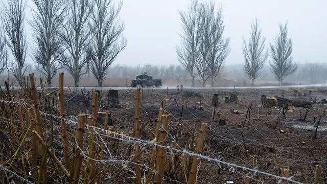 epa11994465 A Ukrainian medical evacuation vehicle transporting wounded soldiers to a medical stabilization point rides past a field with fortification constructions, near the frontline city of Pokrovsk, Donetsk region, eastern Ukraine, 28 March 2025, amid the Russian invasion. These Ukrainian Army facilities are the first point of care for wounded soldiers before they are transferred to hospitals. EPA/SERGEY SHESTAK