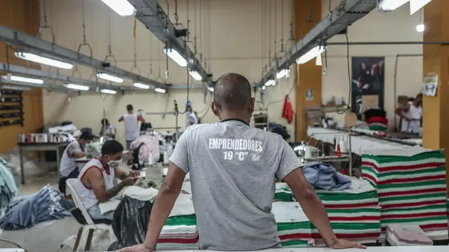 epa09936160 Inmates work in the industrial pavilion of the Lurigancho prison in Lima, Peru, 03 April 2022 (issued 09 May 2022). Clemente Espinosa was imprisoned three years ago in Lurigancho, the most populous prison in Peru. Since then, a sewing machine has been his best ally to pass the time and earn a few soles making clothes that are sold in New York and Madrid under the Pieta label, an ethical fashion brand that encourages reintegration. The architect of all this is Thomas Jacob, a Frenchman born 34 years ago in the Brittany region, who has been living in Peru for more than a decade. EPA/ALDAIR MEJIA