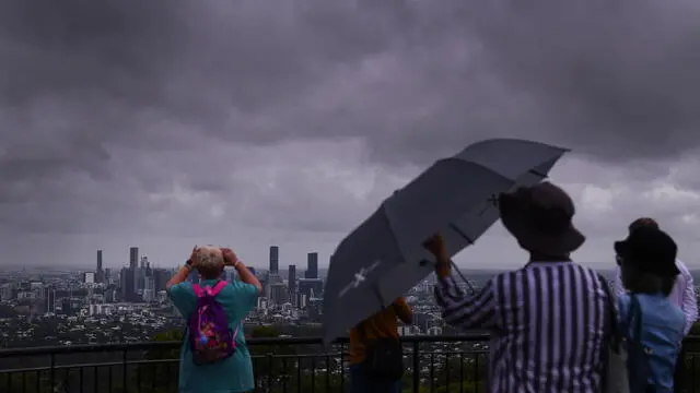 epa11991281 Tourists observe the weather at Mt Cootha in Brisbane, Queensland, Australia, 27 March 2025. EPA/JONO SEARLE AUSTRALIA AND NEW ZEALAND OUT