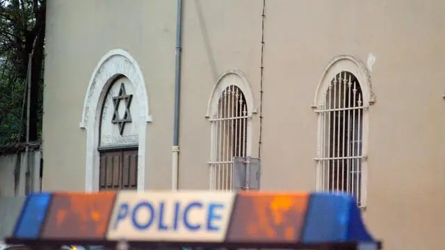 MPL02 - 20020404 - MONTPELLIER, FRANCE : A French police car sits 04 April 2002 in front of the Montpellier synagogue, part of a building into which unknown assailants flung molotov cocktails without causing any damage. The firebombs were thrown through a window and started a brief blaze in local government offices next door to the synagogue. The fire was quickly extinguished. EPA PHOTO AFP / DOMINIQUE FAGET