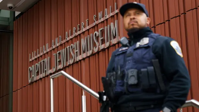 epaselect epa12126607 A police officer stands guard at the scene where two people were shot and killed near the Capital Jewish Museum in Washington, DC, USA, 22 May 2025. According to a social media post by the US Homeland Security Secretary Kristi L. Noem, the two people killed last night were staff members at the Israeli embassy. EPA/WILL OLIVER